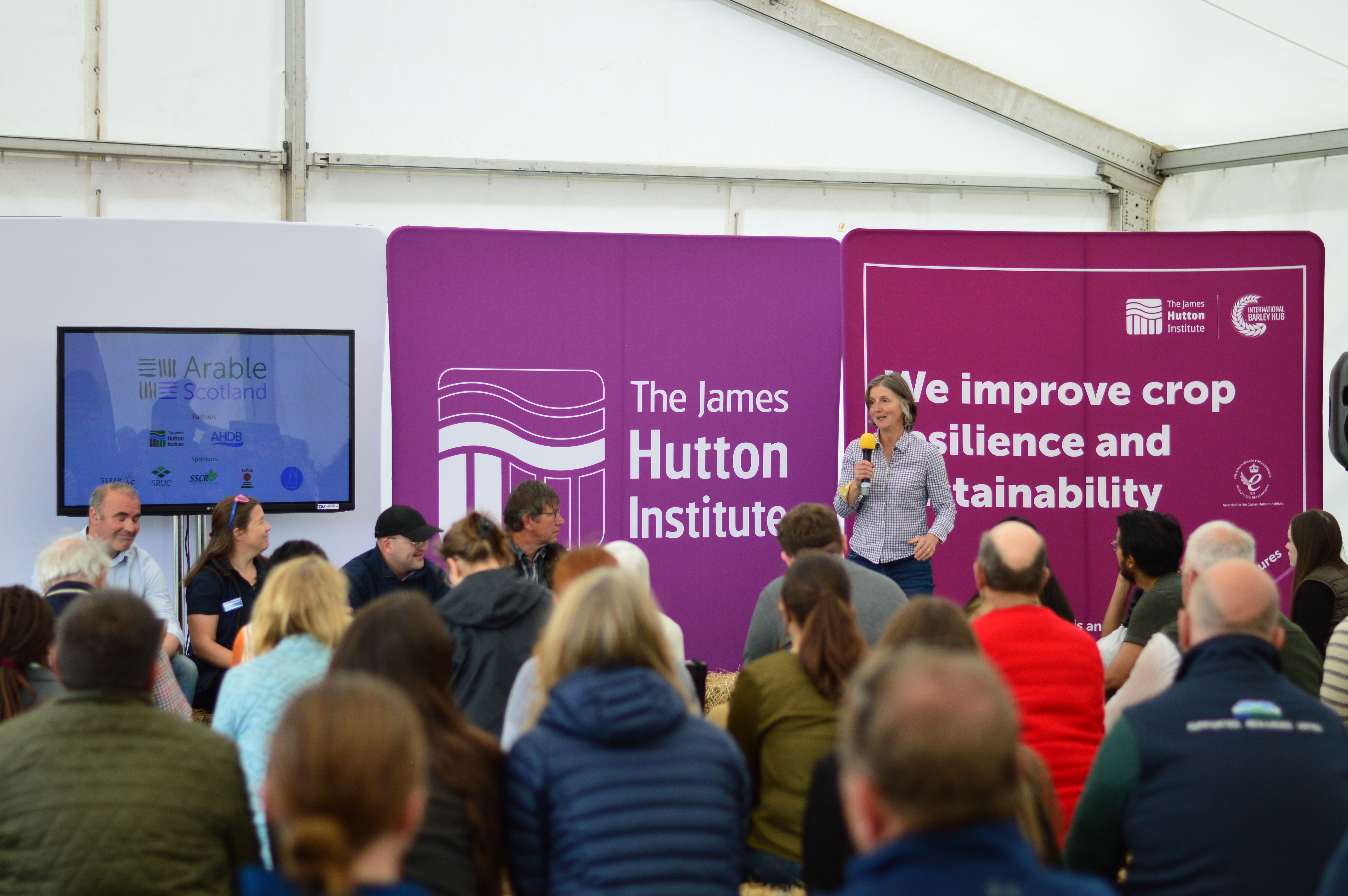 panel session in marquee with main speaker and 4 panellists 