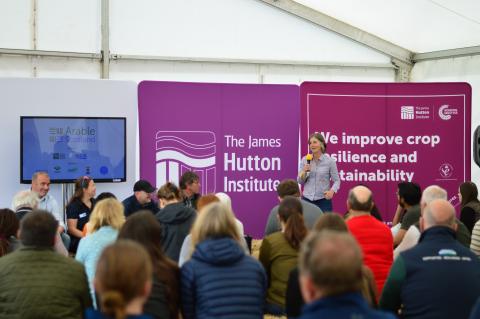 panel session in marquee with main speaker and 4 panellists 