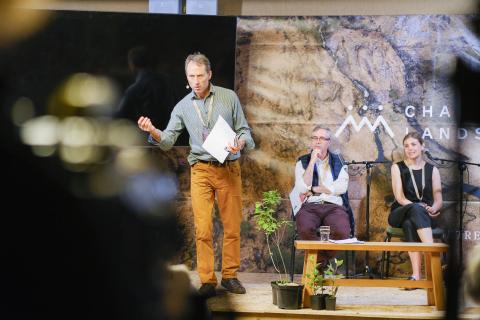 Rob Yorke on stage at an event speaking to audience 